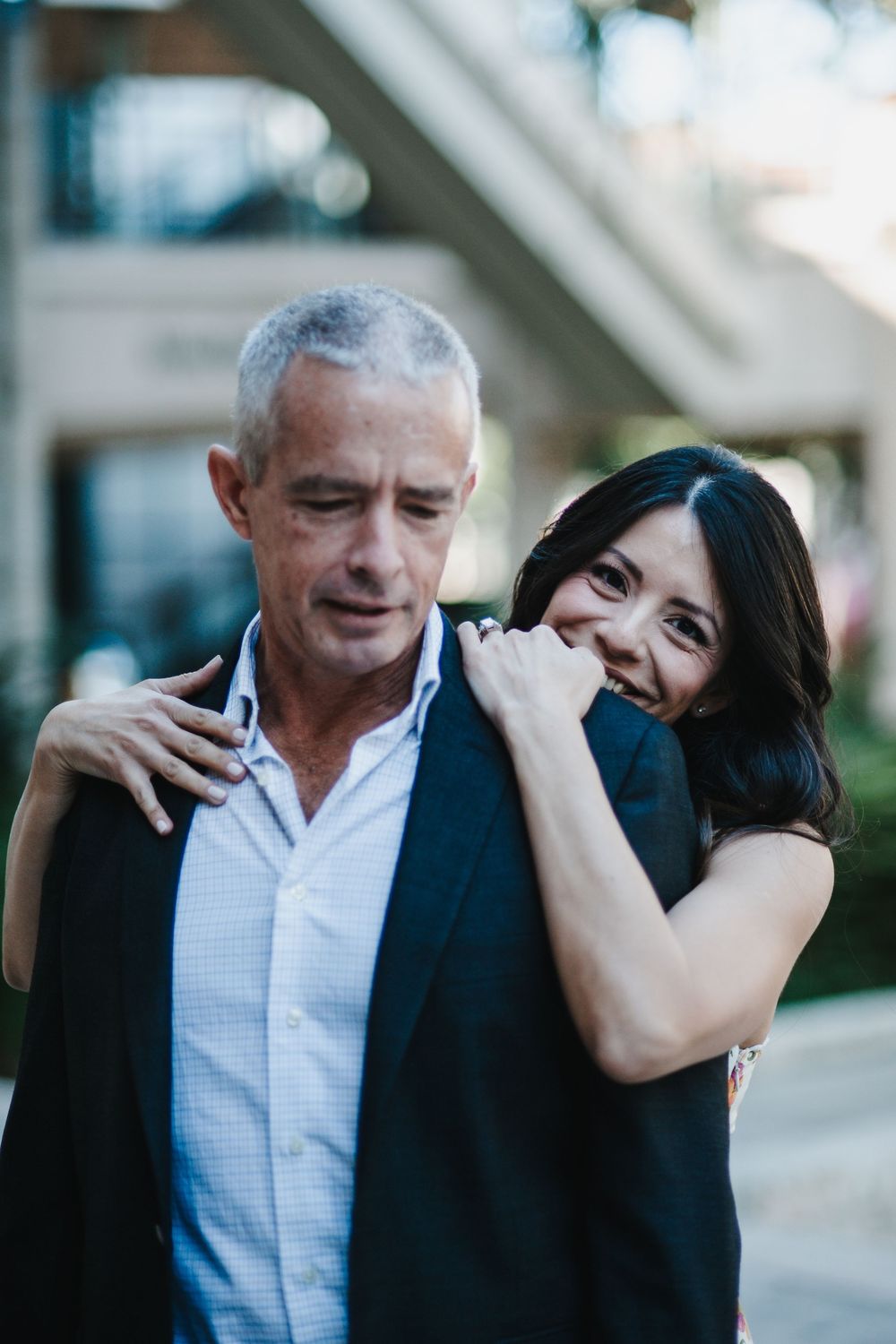 A couple shares an intimate moment together in a series of candid outdoor photos.