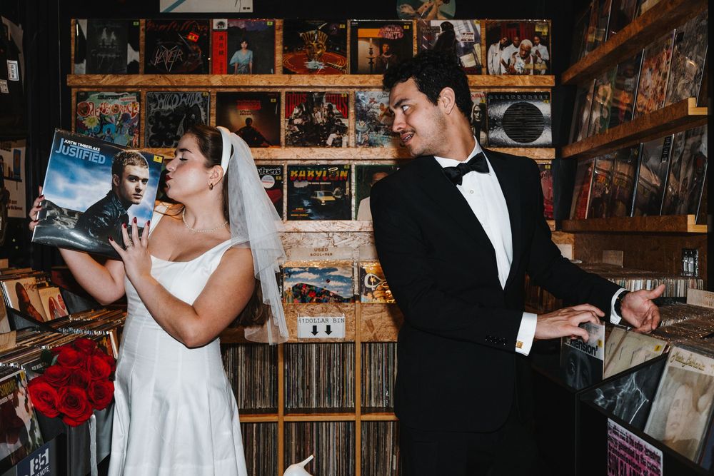 Bride and groom share an intimate moment during their wedding reception in a rustic venue with warm lighting.