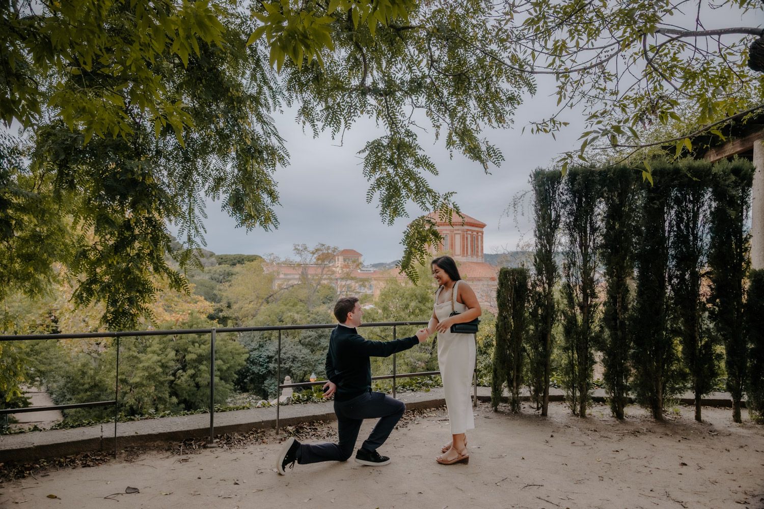 Shy couple enjoying a quiet proposal moment in Barcelona
