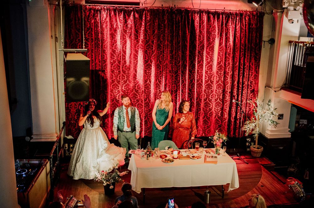 Red sequin backdrop creates a glamorous setting for an elegant event with chairs arranged in front.