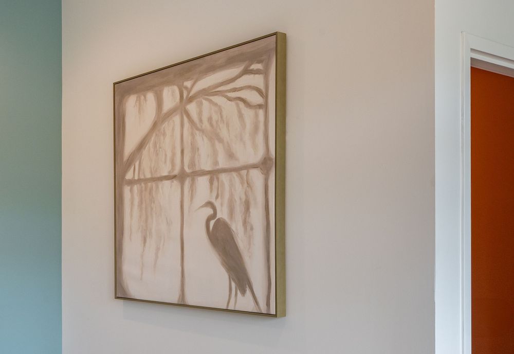 Modern art gallery wall displaying a series of framed neutral-toned paintings with minimalist designs.
