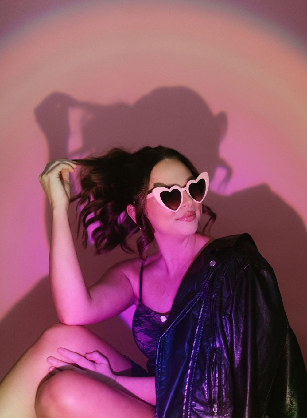 Artistic photo sequence showing figure in blue fabric against pink backdrop with dramatic shadows and movement.
