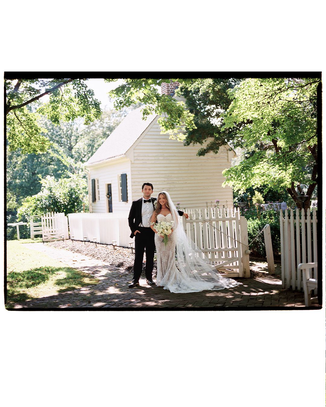 Wedding photography session at a charming colonial house with white picket fence.