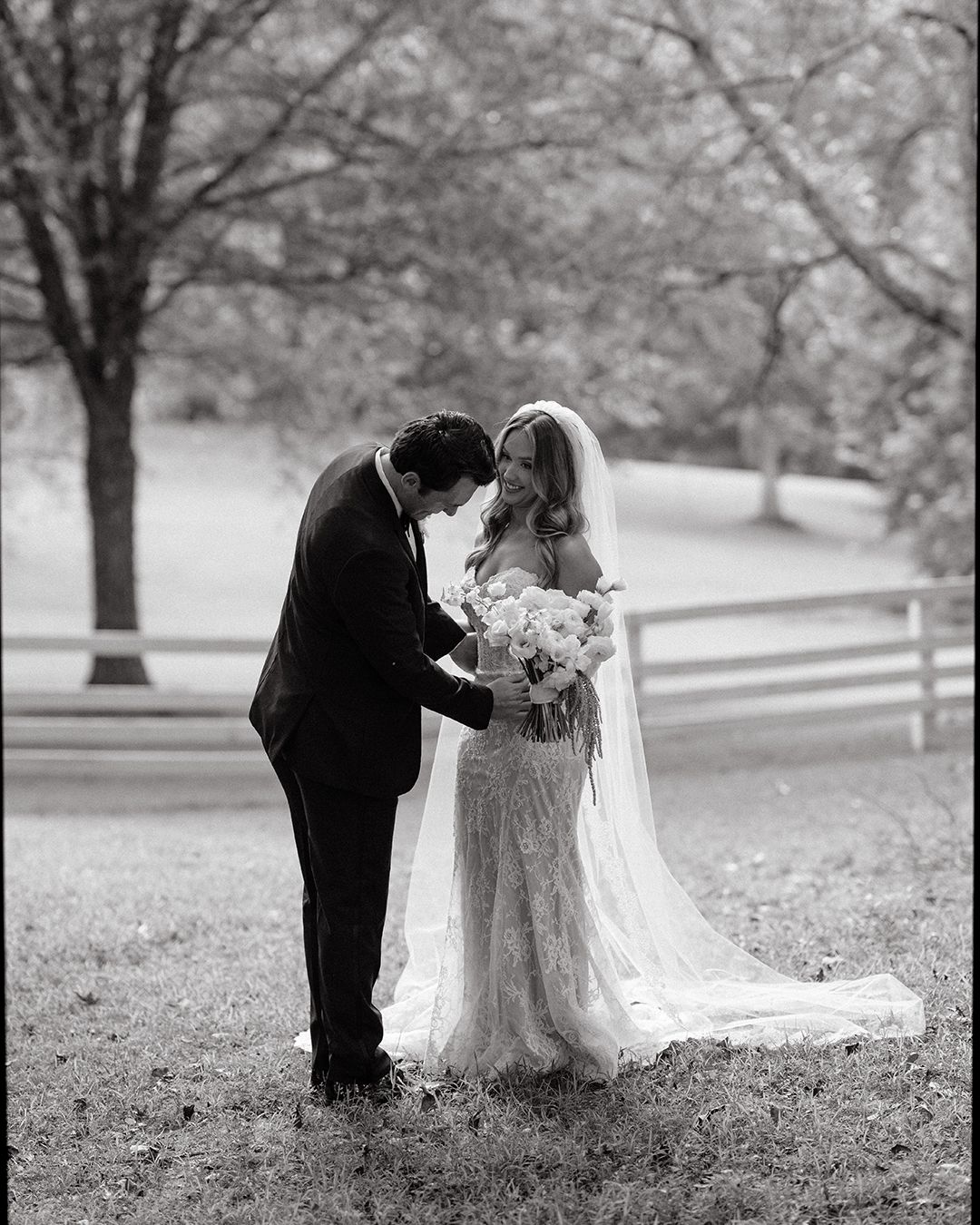 A romantic black and white wedding photography sequence showing a couple embracing under trees in a park setting.