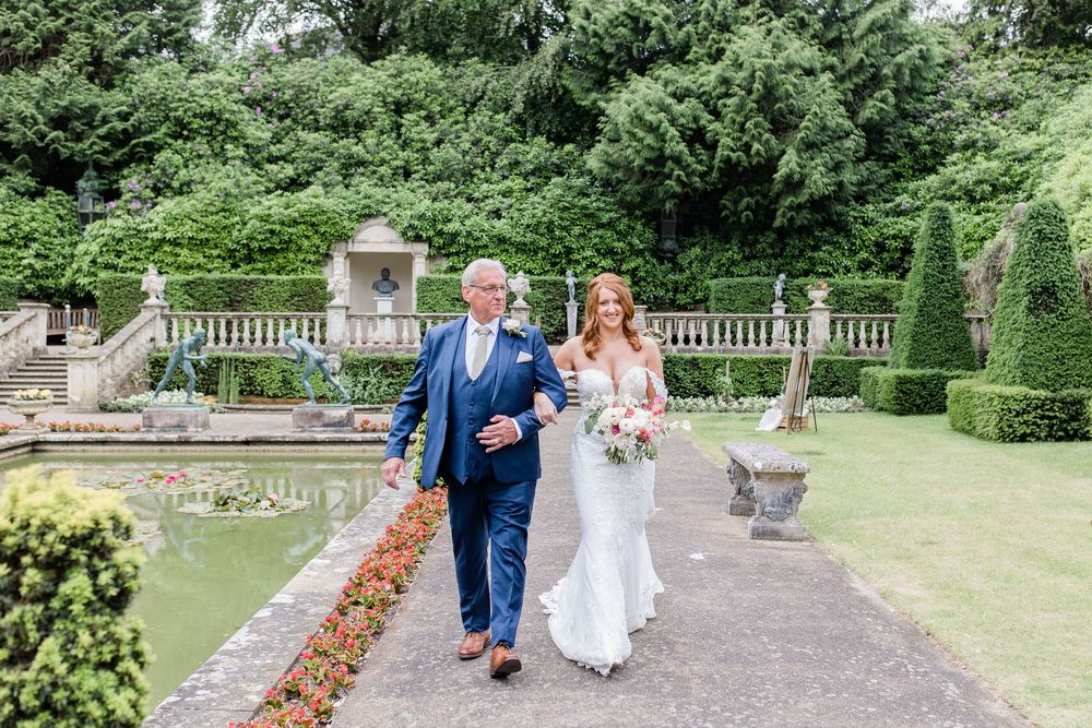 Bride and her Dad walking to outside ceremony at the Italian Villa by Maddie Waters Wedding Photographer