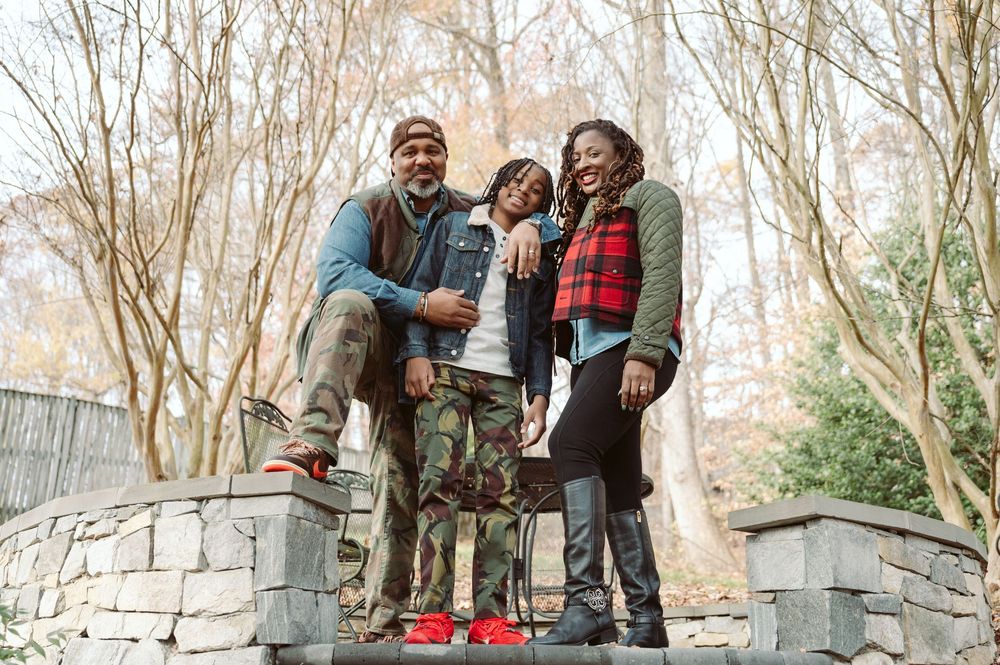 Group of people enjoying a casual gathering on stone steps surrounded by bare trees in an outdoor setting.