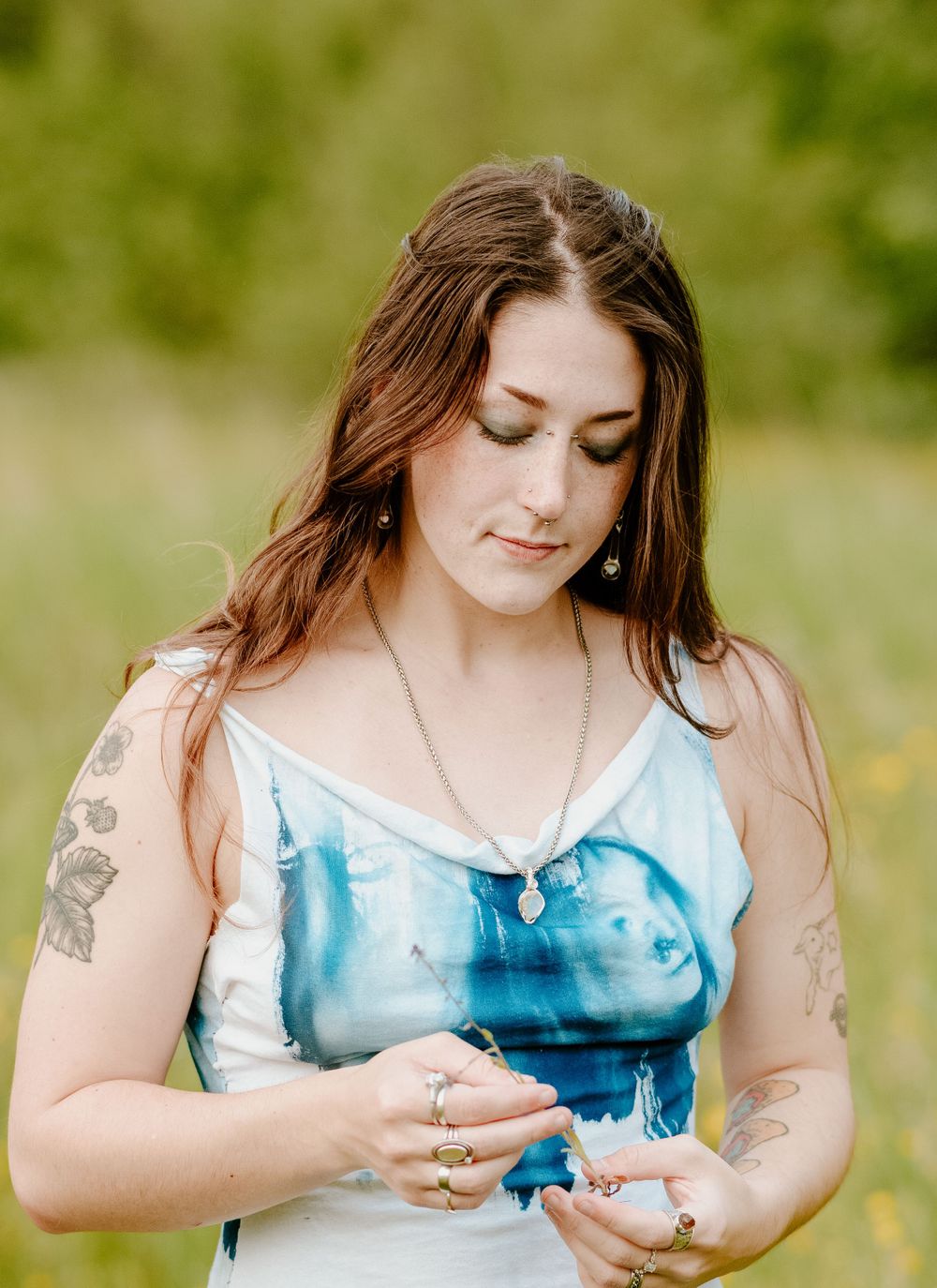 Close-up shots showcasing details of a blue and white tie-dye dress in a sunny meadow.