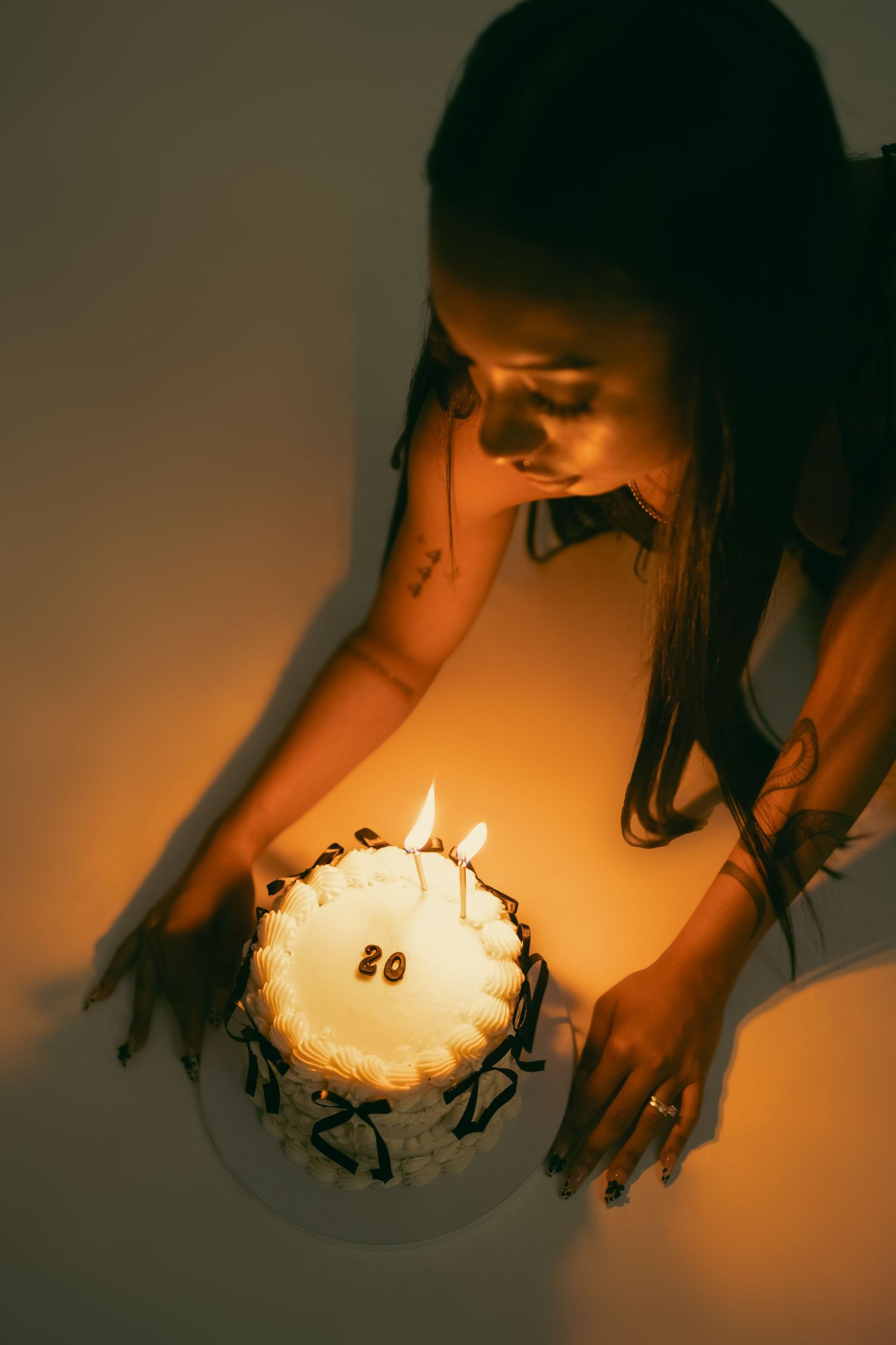 Portrait in red ruffled dress holding dessert with playful expression.