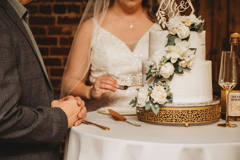 Bride and groom with wedding cake Lafayette event space