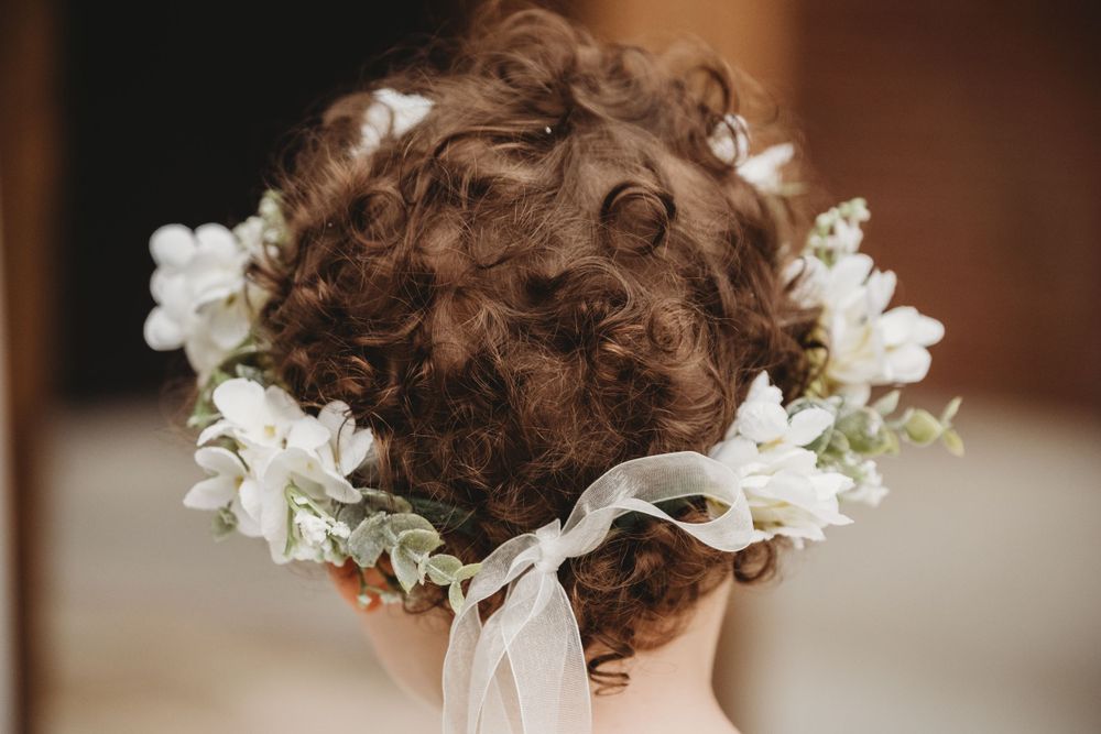 small child with curly hair and flower crown Lafayette event space