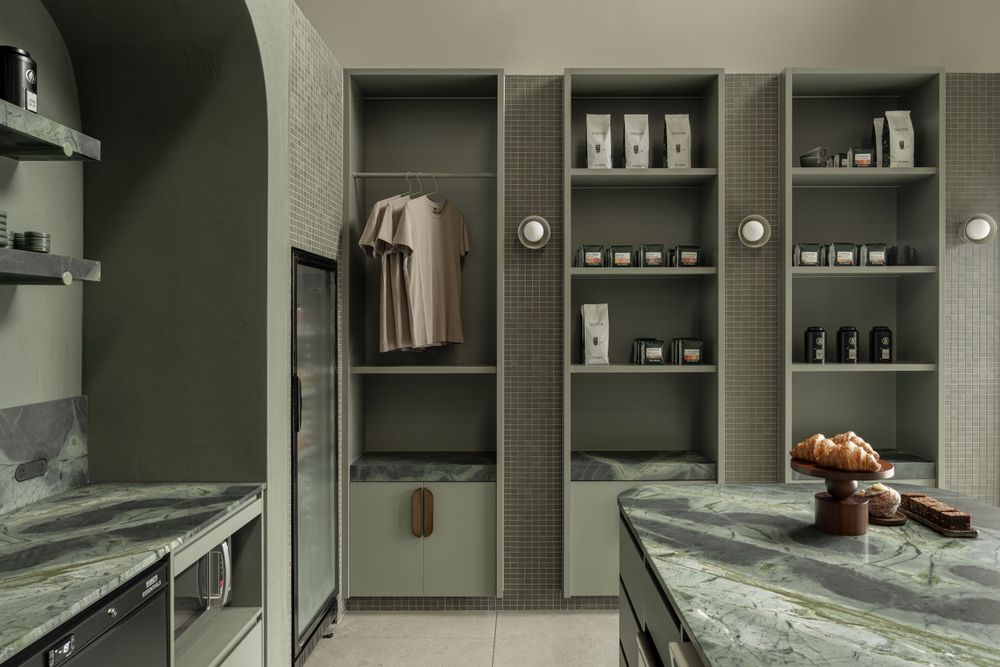 Contemporary gray cafe storage area with marble counters and organized retail display shelves.