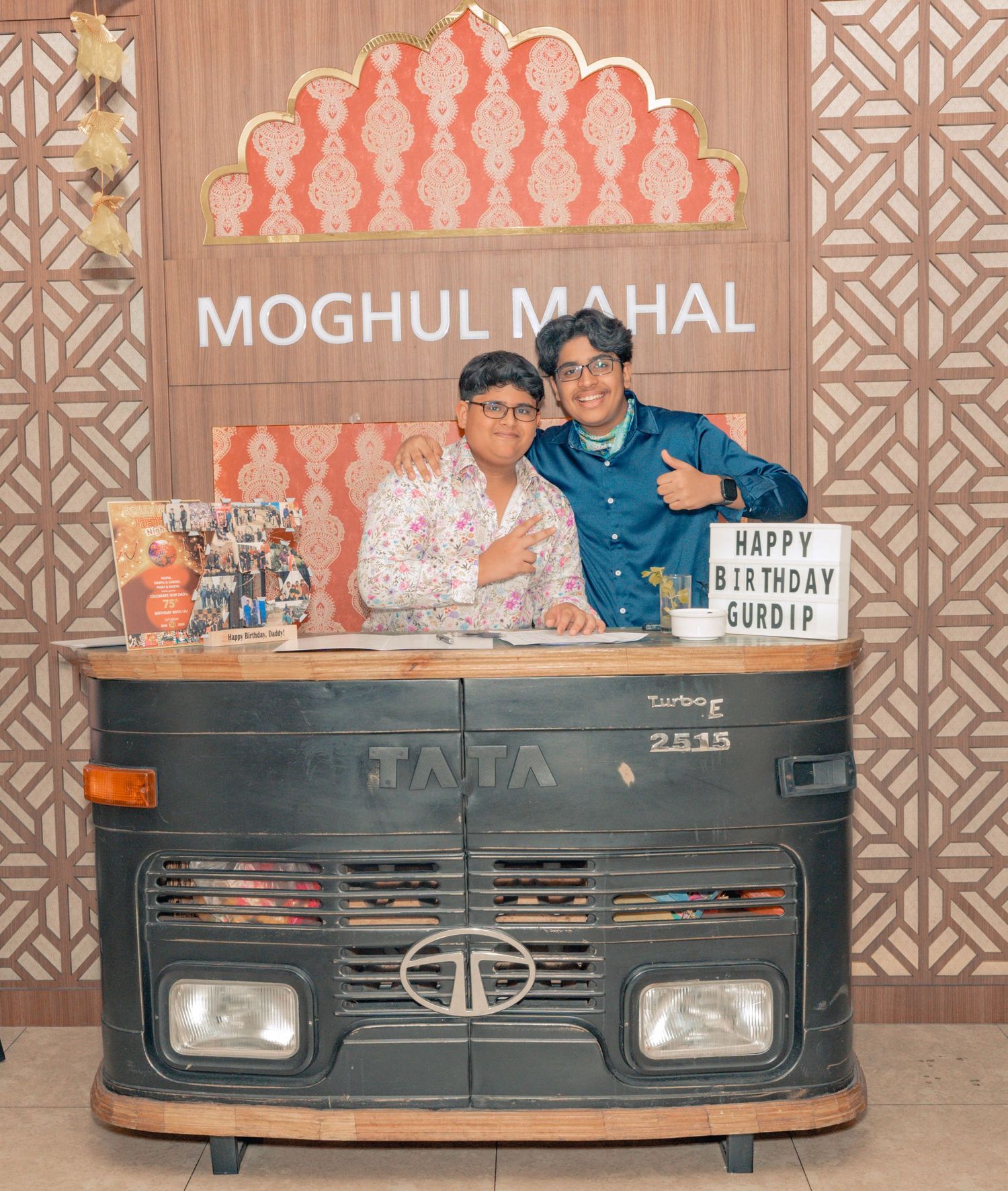 Moghul Mahal branded rustic food truck display with decorative panel backdrop.
