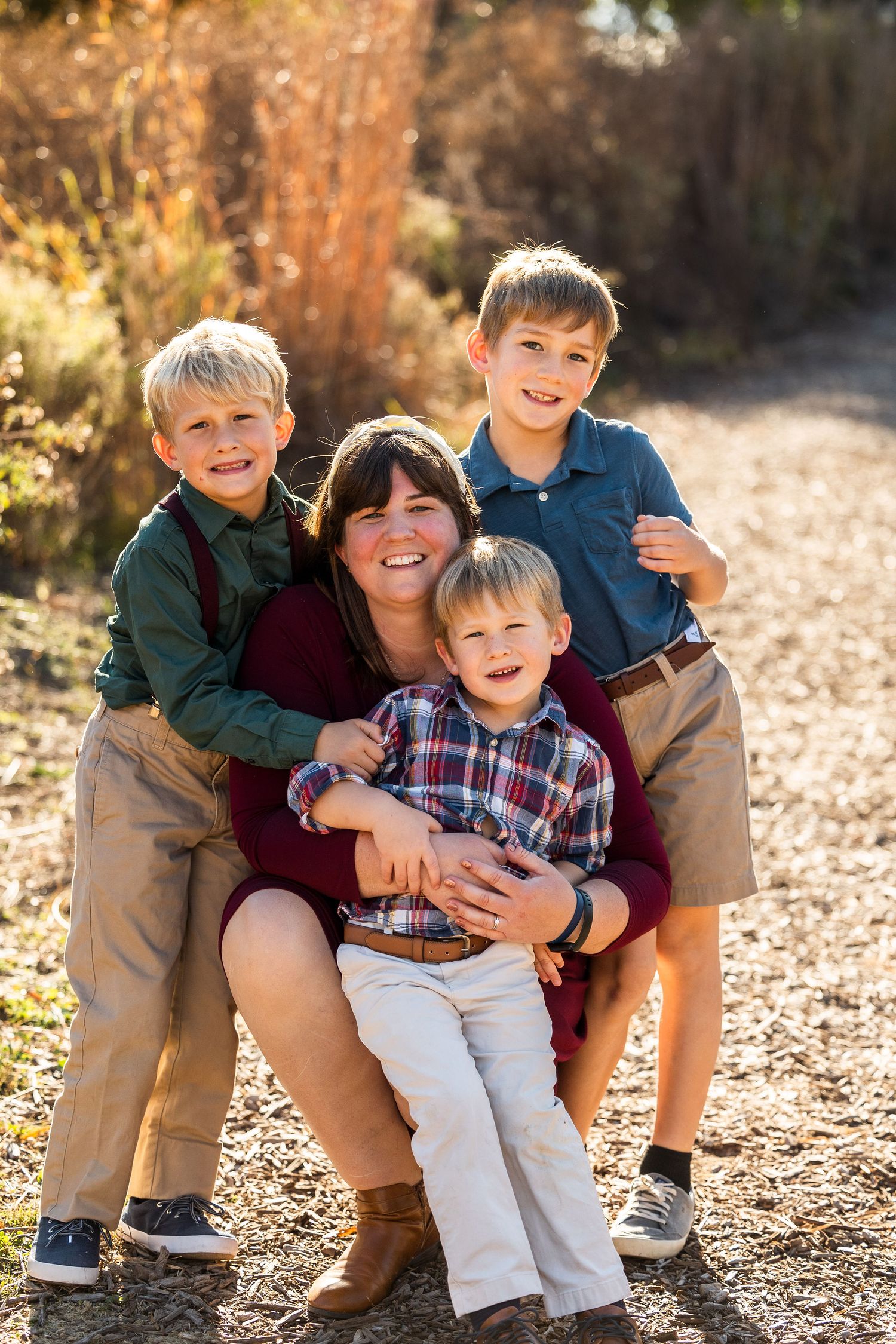 Family group sharing laughs during casual outdoor photo session.