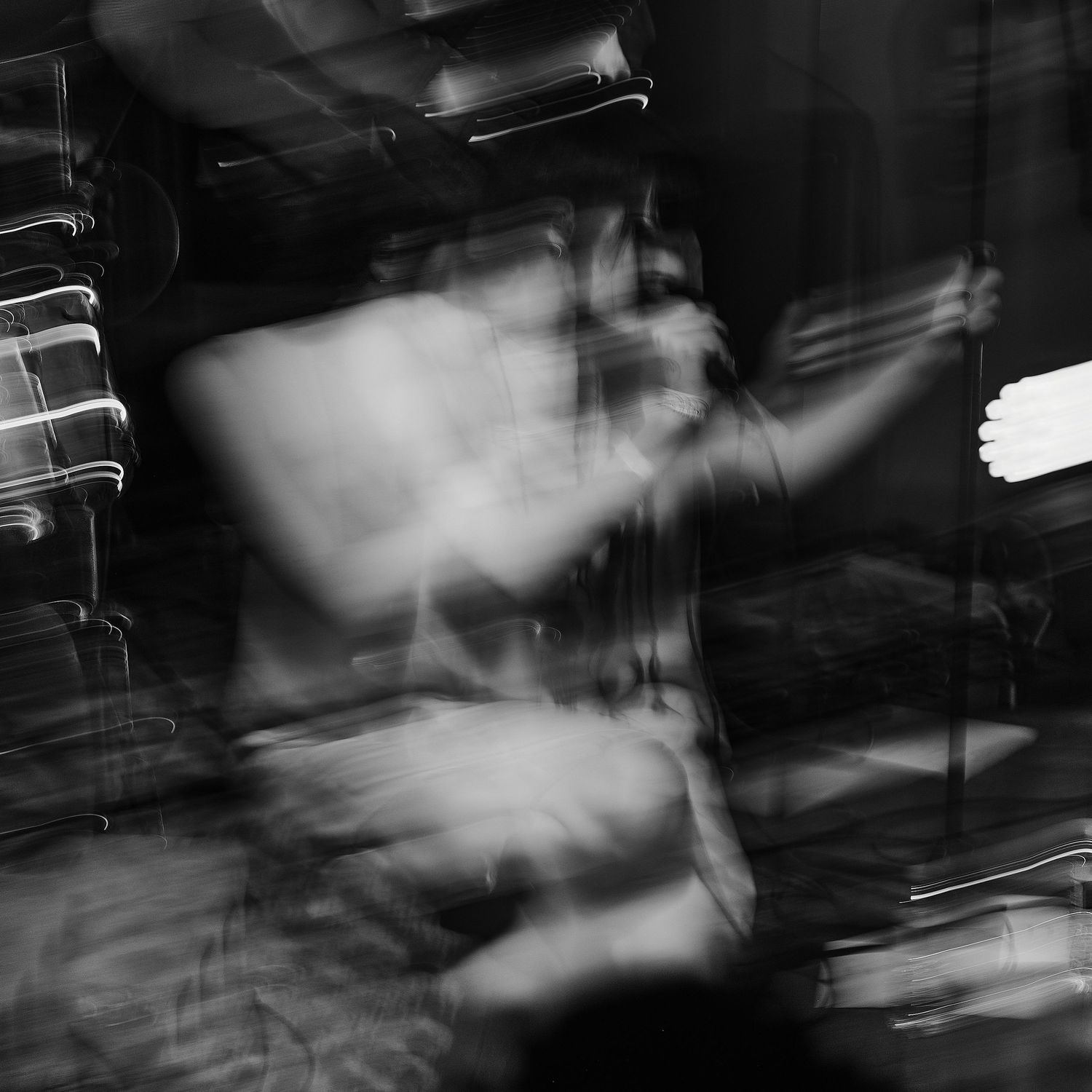 Abstract black and white motion blur photography with streaks of light.