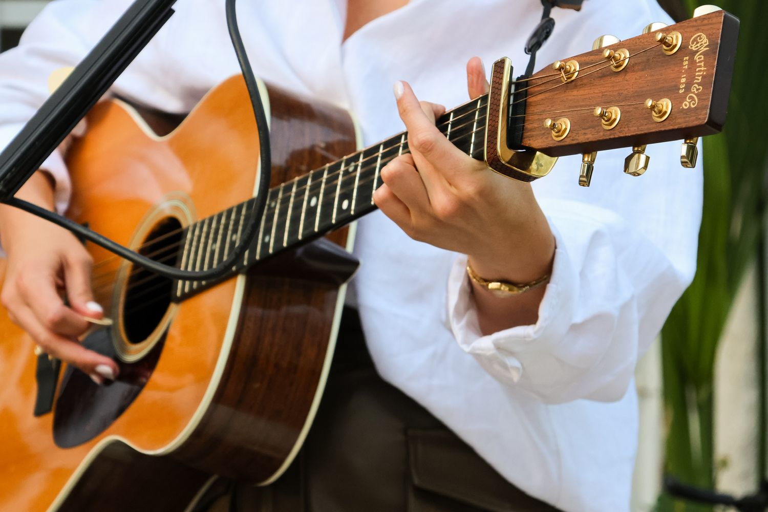 woman's hands playing guitar