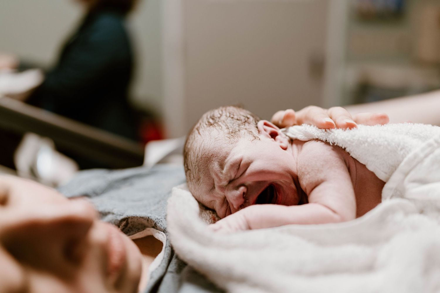 Collage of newborn baby photos showing tender moments with parents in soft, natural lighting.