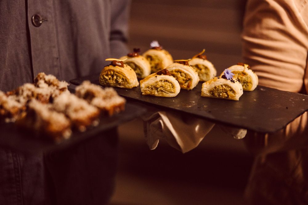 Guests enjoy craft beers and appetizers at a dimly lit restaurant bar.