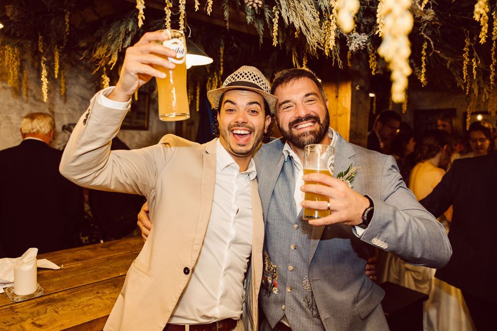 People raise their glasses in a celebratory toast at an evening gathering.