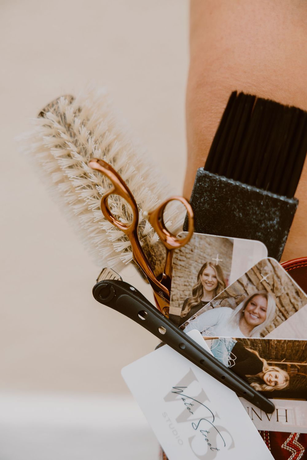 Artistic collage showing photographs scattered on a beige surface with decorative dried pampas grass elements.
