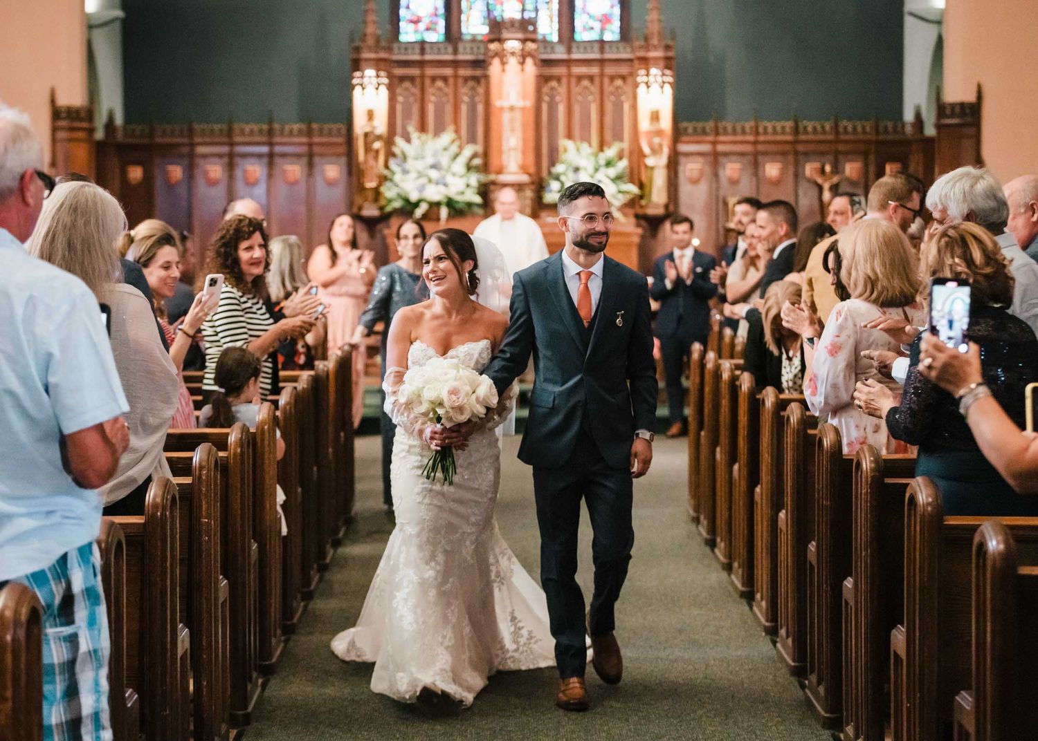 Bride and groom walking down the aisle after their wedding ceremony at Saint Brigid Church in South Boston