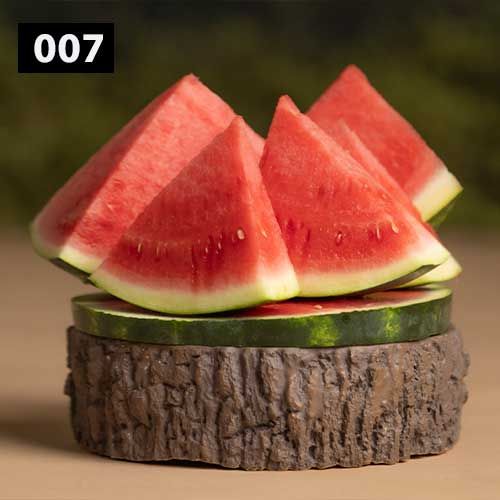 Fresh watermelon slices arranged on a rustic wooden serving board.