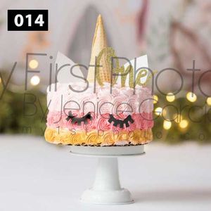 Pink and gold princess themed cake with crown topper on white pedestal stand.