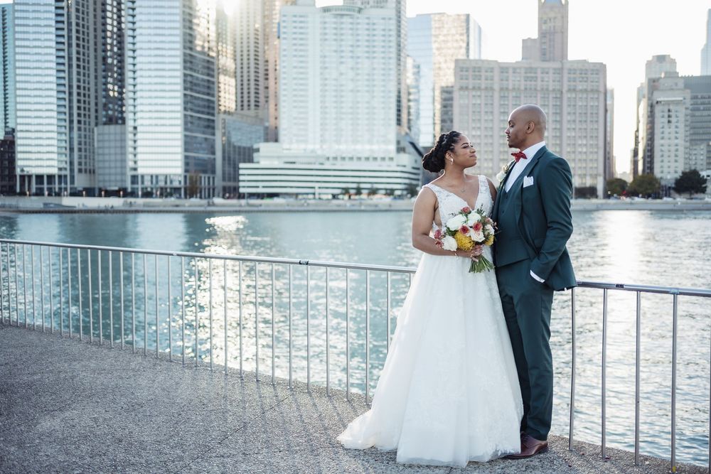 A couple shares an intimate moment during their wedding photoshoot against the Miami skyline and waterfront backdrop.