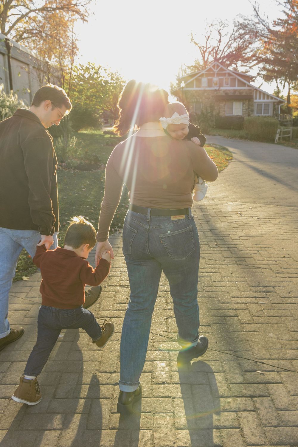 A series of four photos showing a child and adult walking together on a brick path during golden hour sunset.