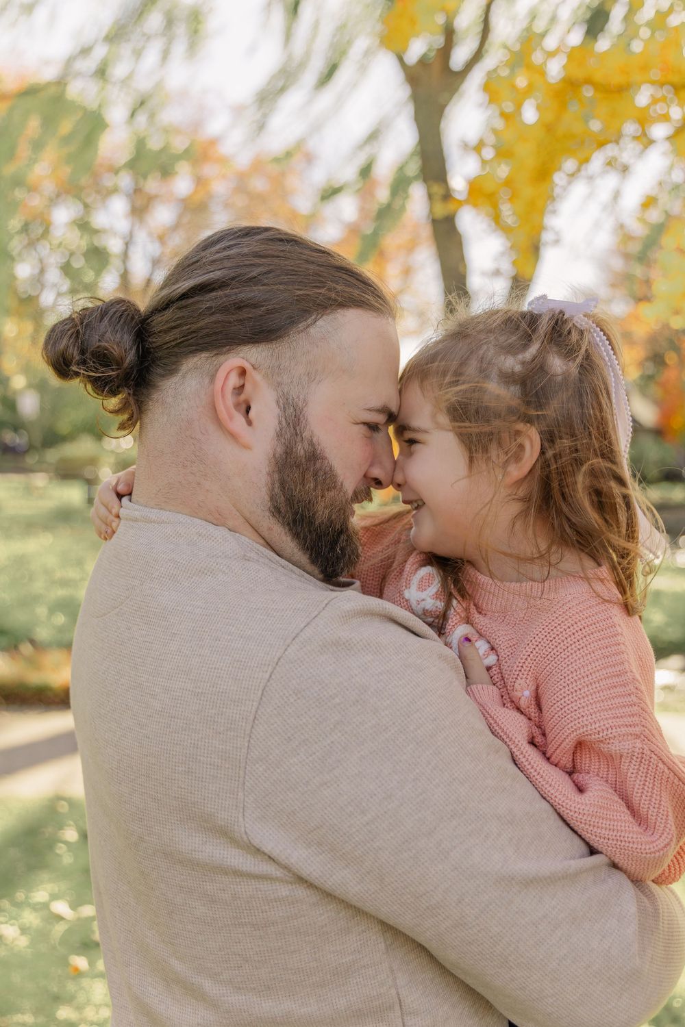 A series of intimate close-up moments captured outdoors with fall foliage in the background.