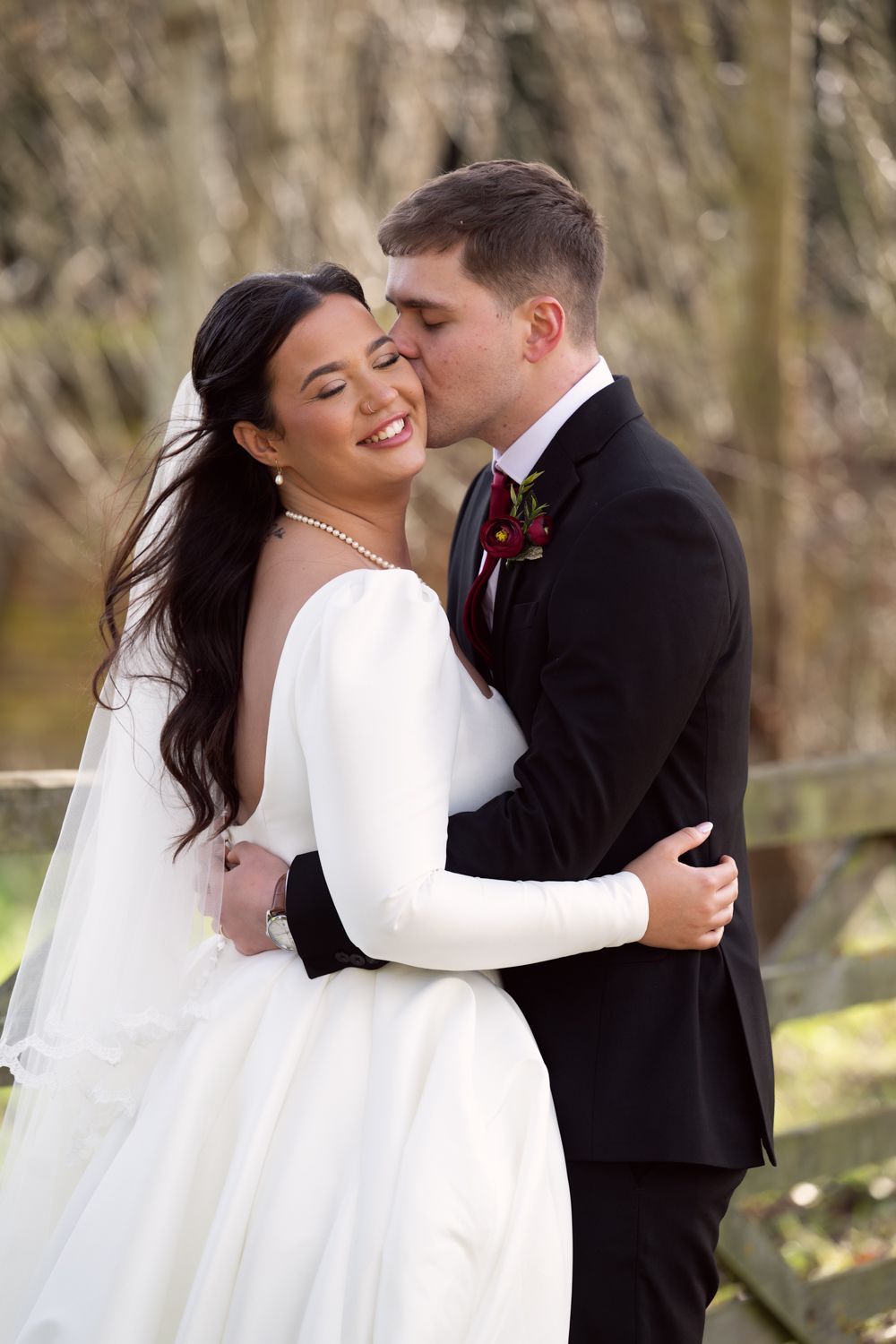 A romantic wedding sequence shows a couple embracing and sharing intimate moments in an outdoor setting with trees.