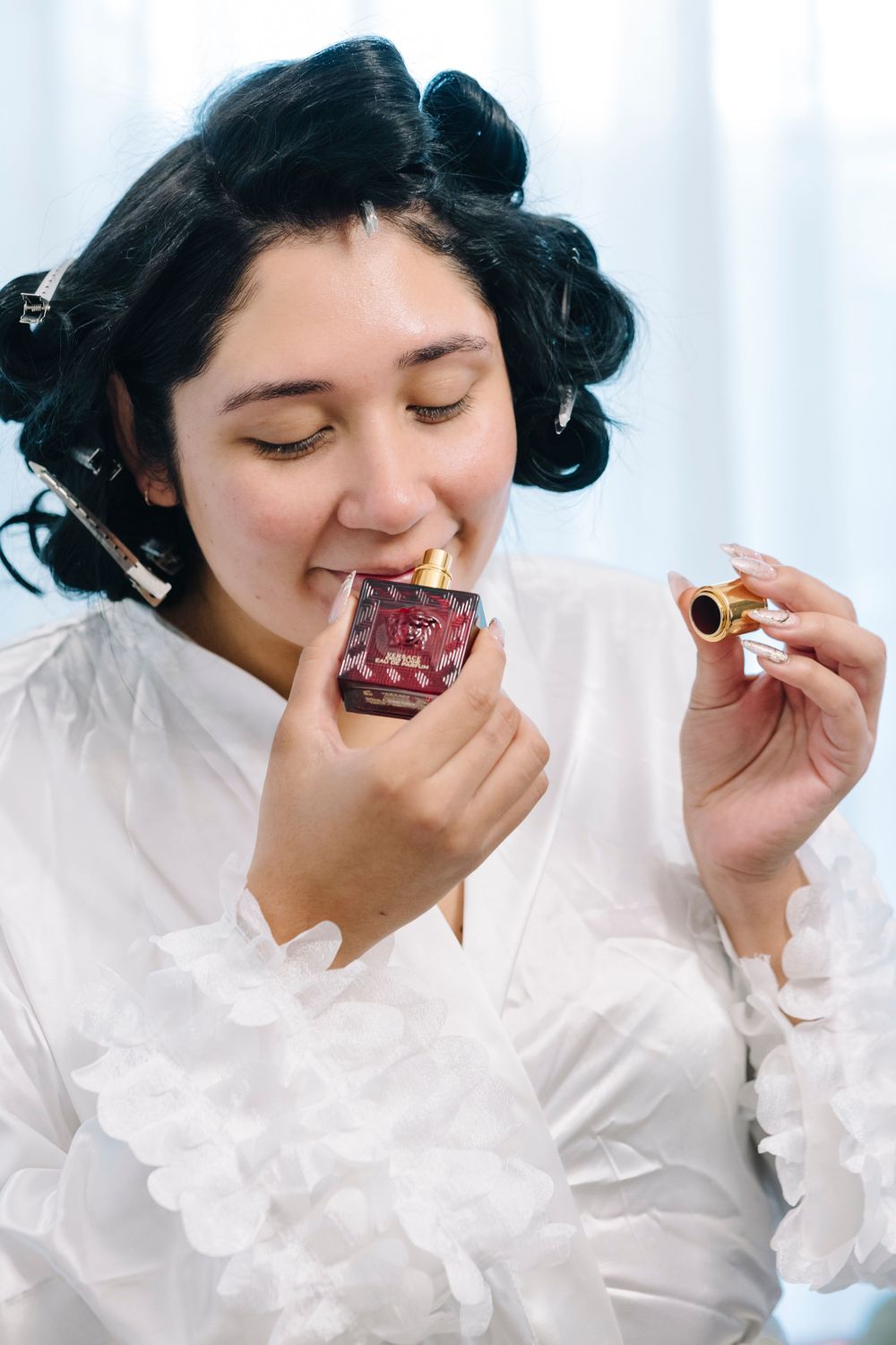 A series of photos showing someone in a white blouse eating a chocolate dessert with a spoon.