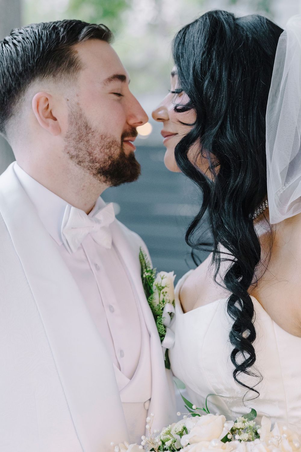 A romantic wedding photo series showing a couple in white sharing intimate moments with a blurred outdoor background.