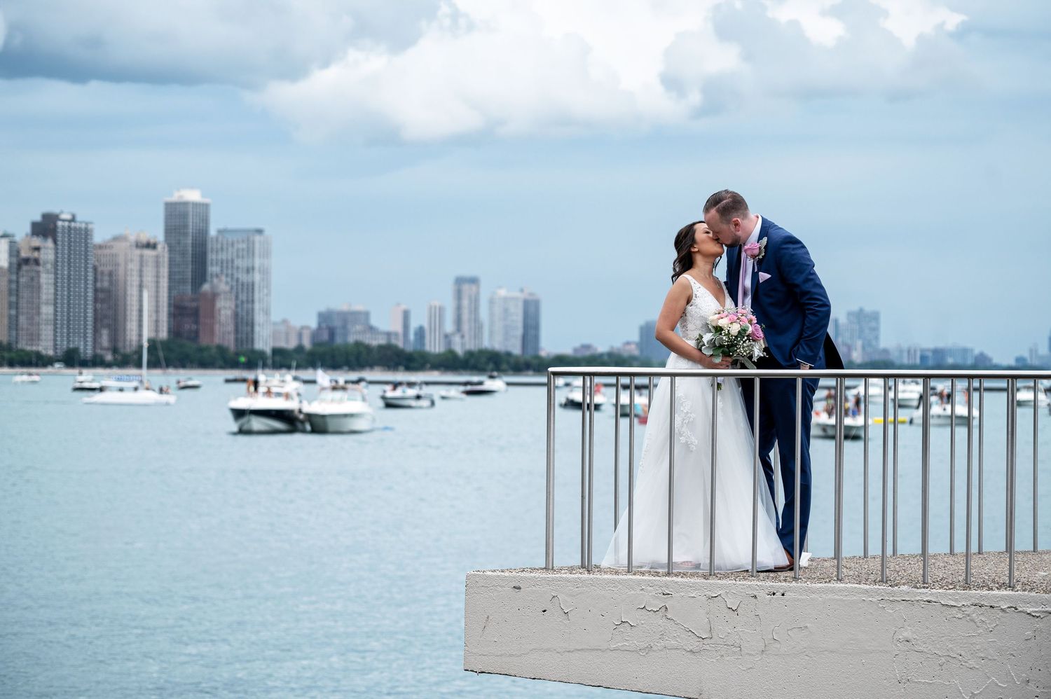 A panoramic Chicago wedding photo showing the Chicago skyline and Lake Michigan waterfront at Milton Lee Olive Park.