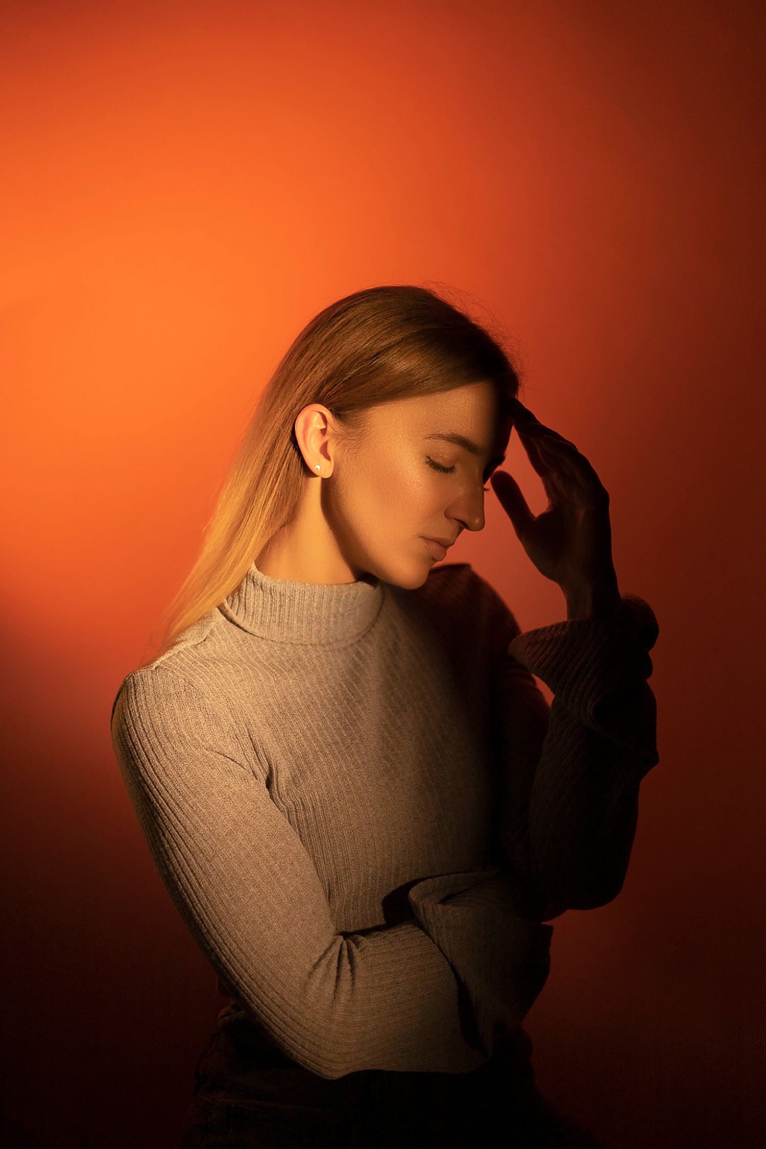 Portrait photography featuring a woman posing with her hand on her head, created by commercial photographer Chris Z of Zeng Studio.