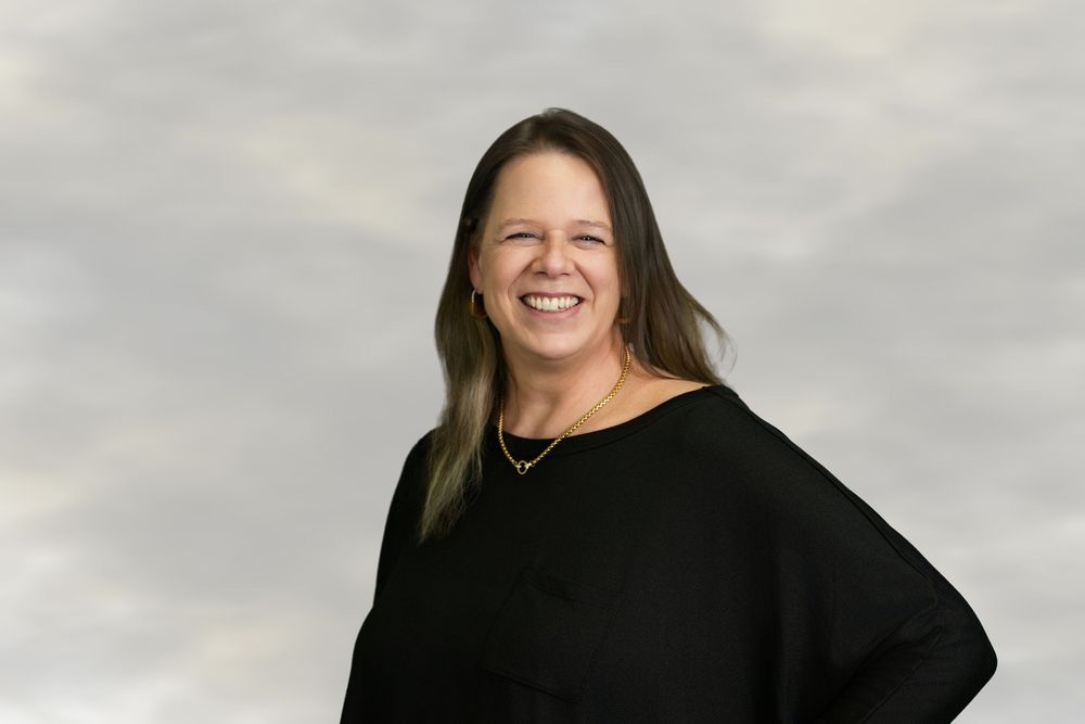 Professional headshot portraits of a person in a black sweater against a light gray background.