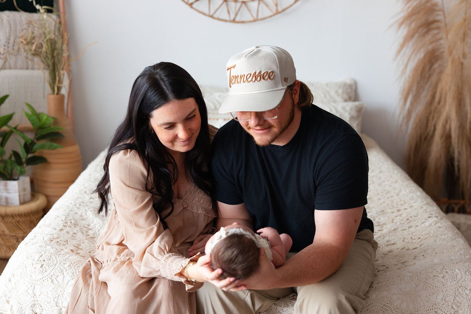 A series of intimate family photos showing tender moments between parents and their newborn baby at home.