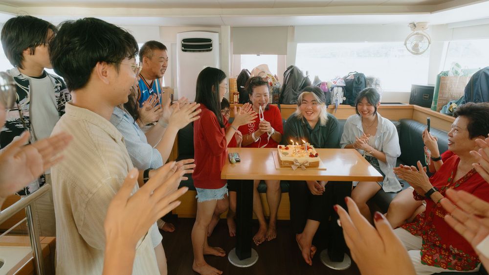 People enjoying a casual gathering in a modern restaurant space with warm lighting and social atmosphere.