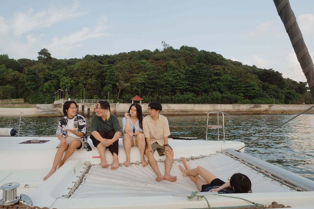Friends enjoying a relaxing day lounging on a boat deck during a sunny summer afternoon on the water.