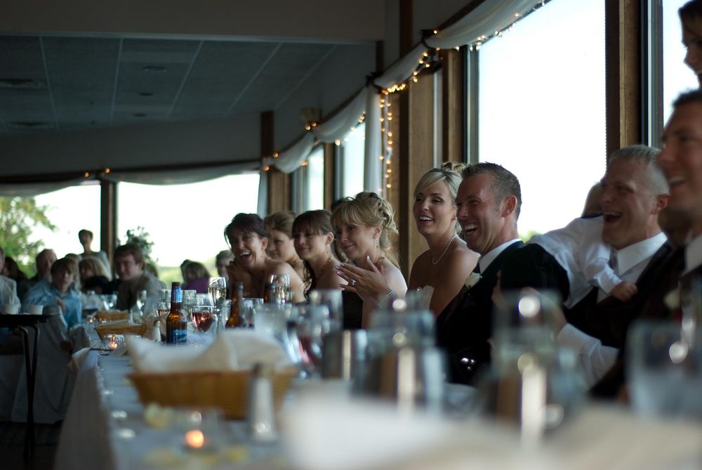 A panoramic view of people gathered in a Denver restaurant dining room with large windows and natural lighting.