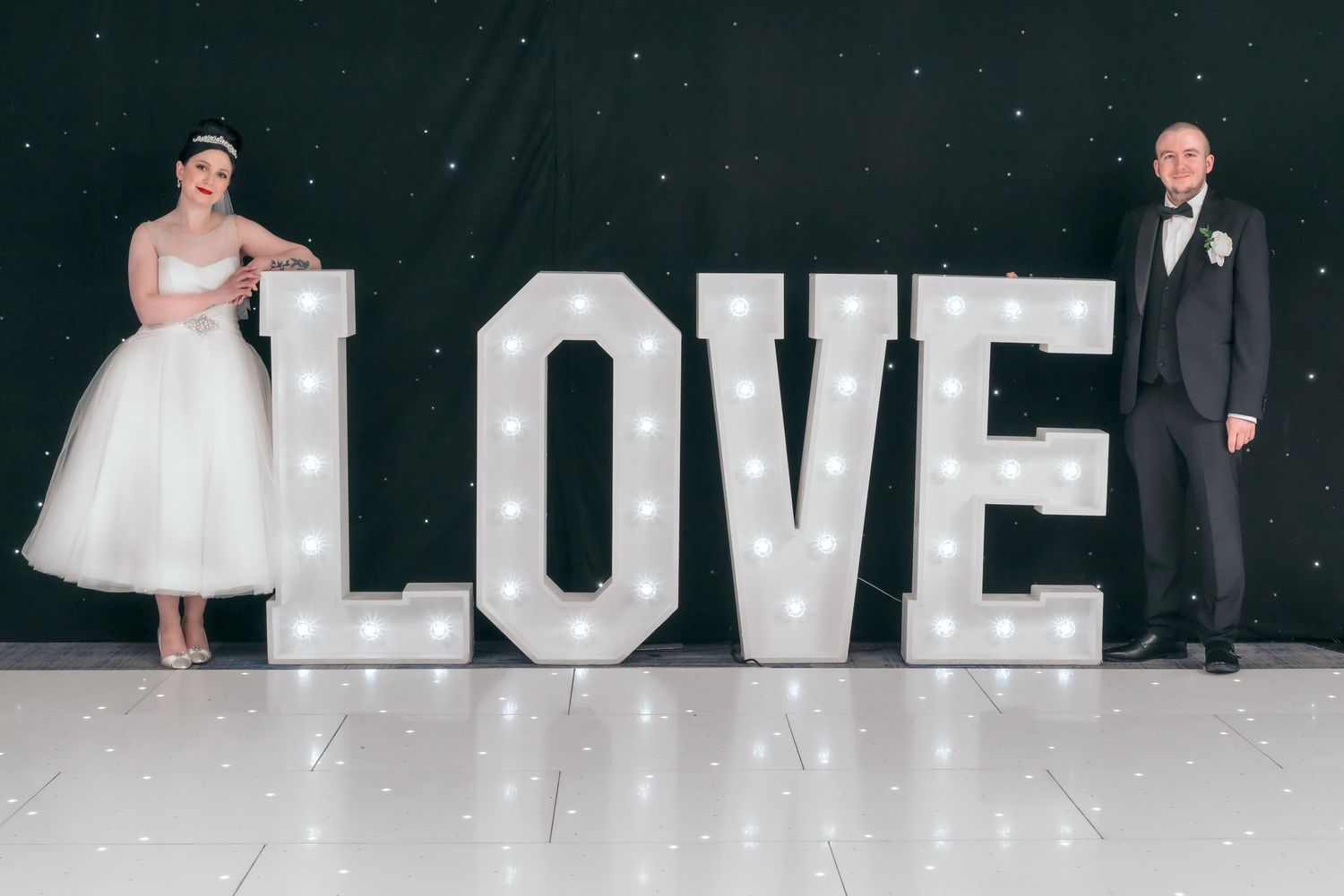 A wedding photo montage shows the word LOVE in large white letters against a dark background.