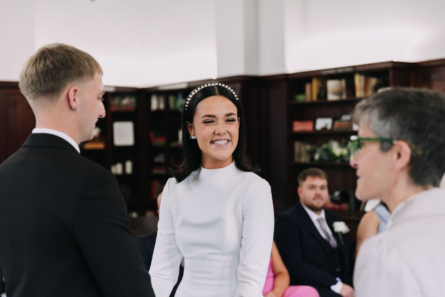 Wedding party members gathered indoors with drinks and smiles during a celebration. Photographer. Hull. East Yorkshire. Photography