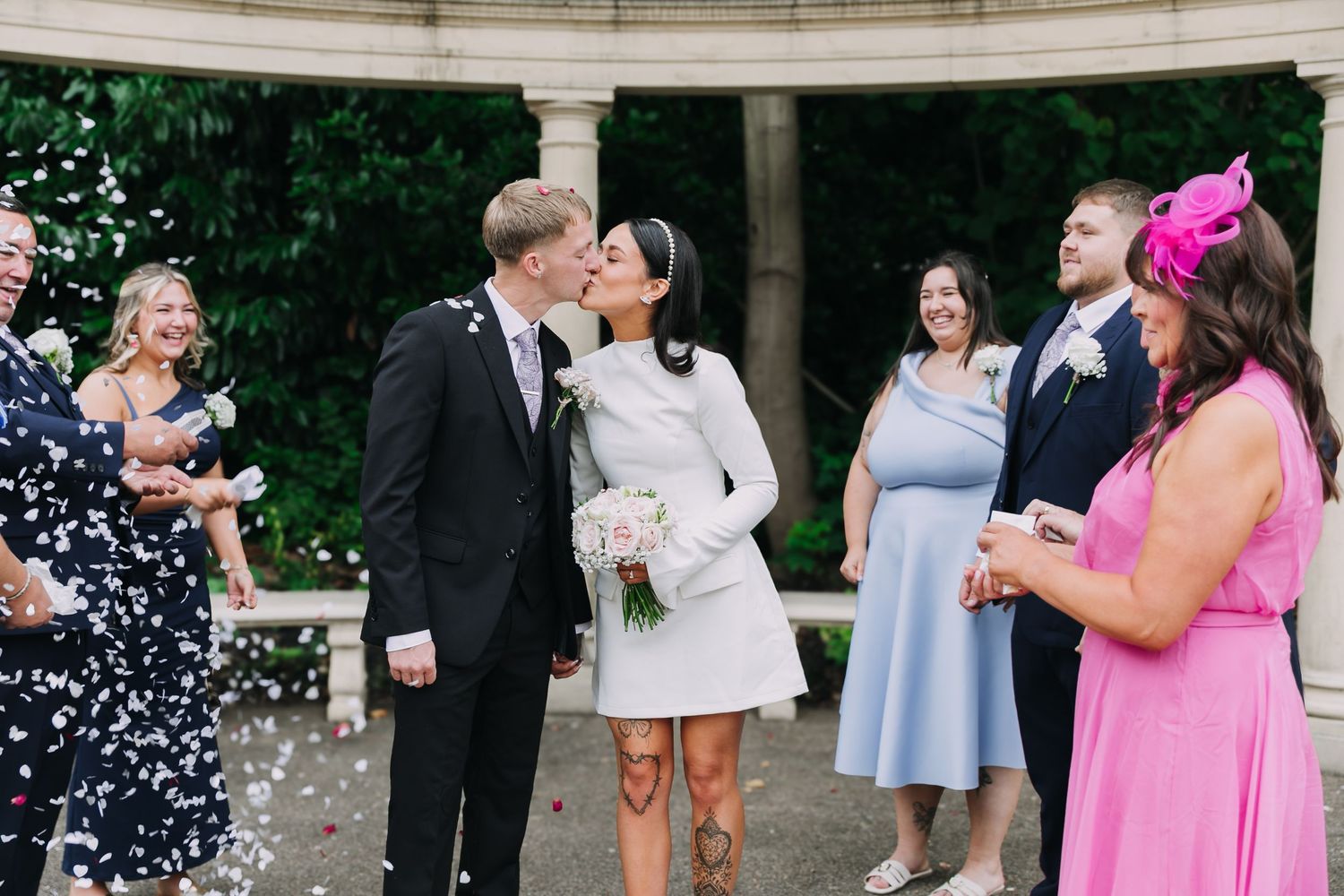 Wedding celebration scene with confetti and guests in formal attire outdoors. Photographer. Hull. East Yorkshire. Photography