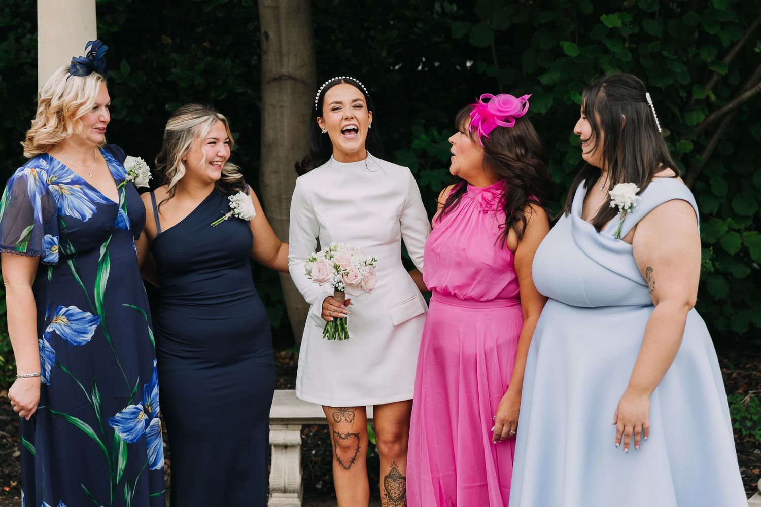 Wedding guests in colourful dresses gathered outdoors for a group photo. Photographer. Hull. East Yorkshire. Photography