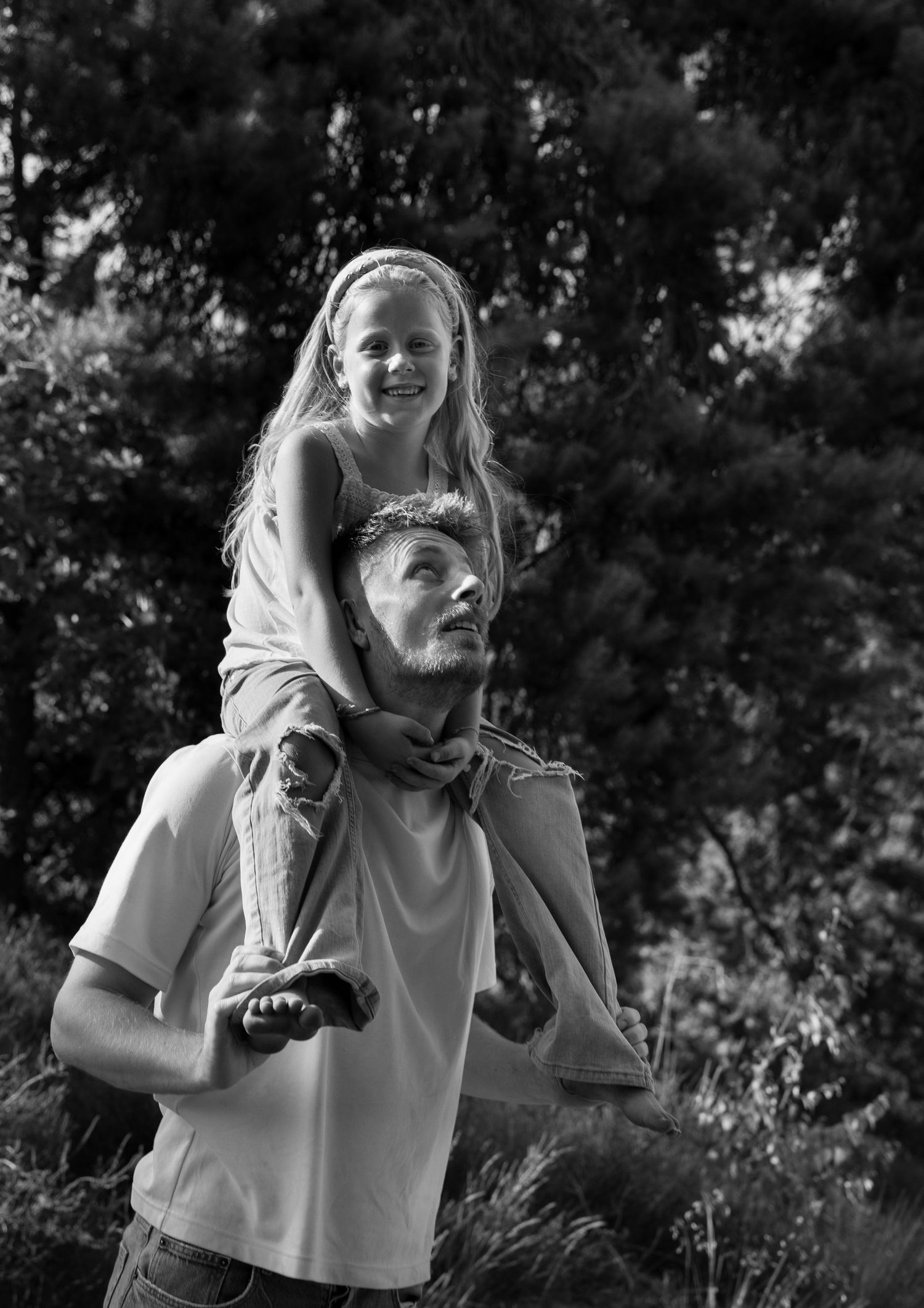 Candid black and white photos of playful moments outdoors.