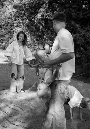 Black and white photos capturing playful family moments outdoors.
