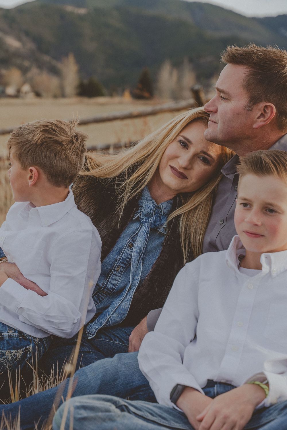 Candid family moments captured in a mountain field during golden hour.