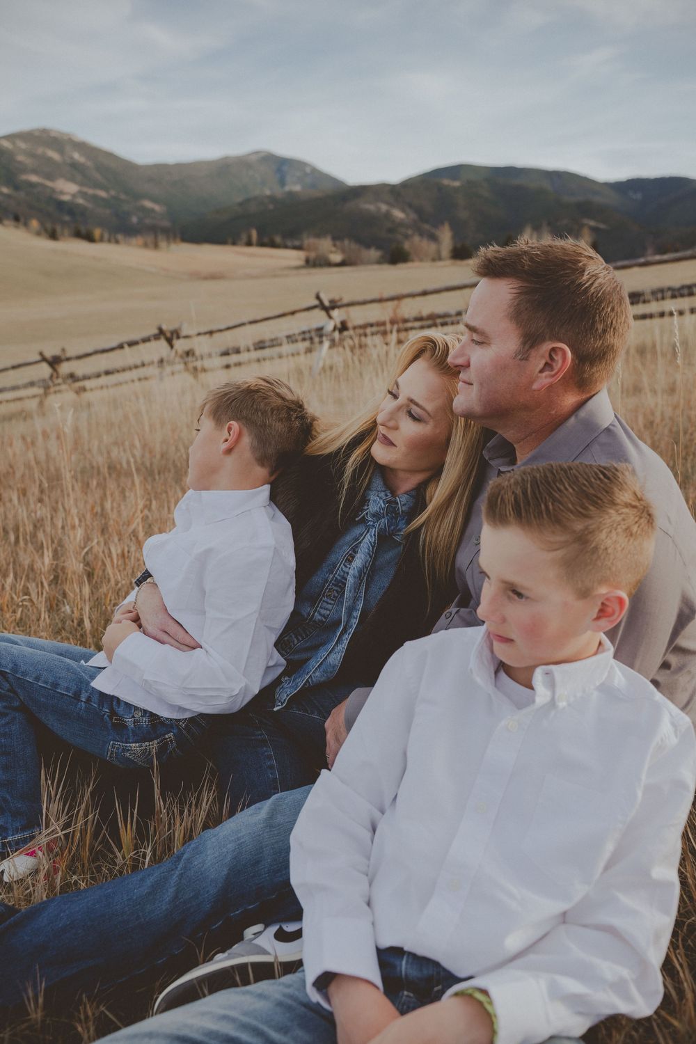 Intimate family portrait session in a mountain meadow during sunset.