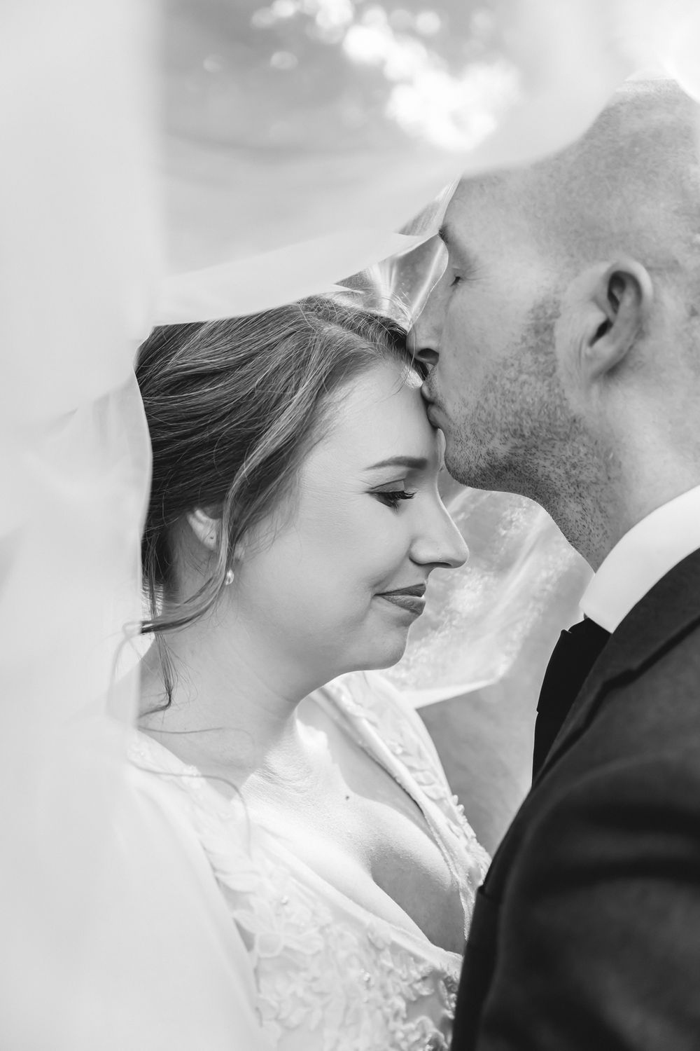 A romantic black and white wedding photo collage showing tender moments between a bride and groom in close-up shots.