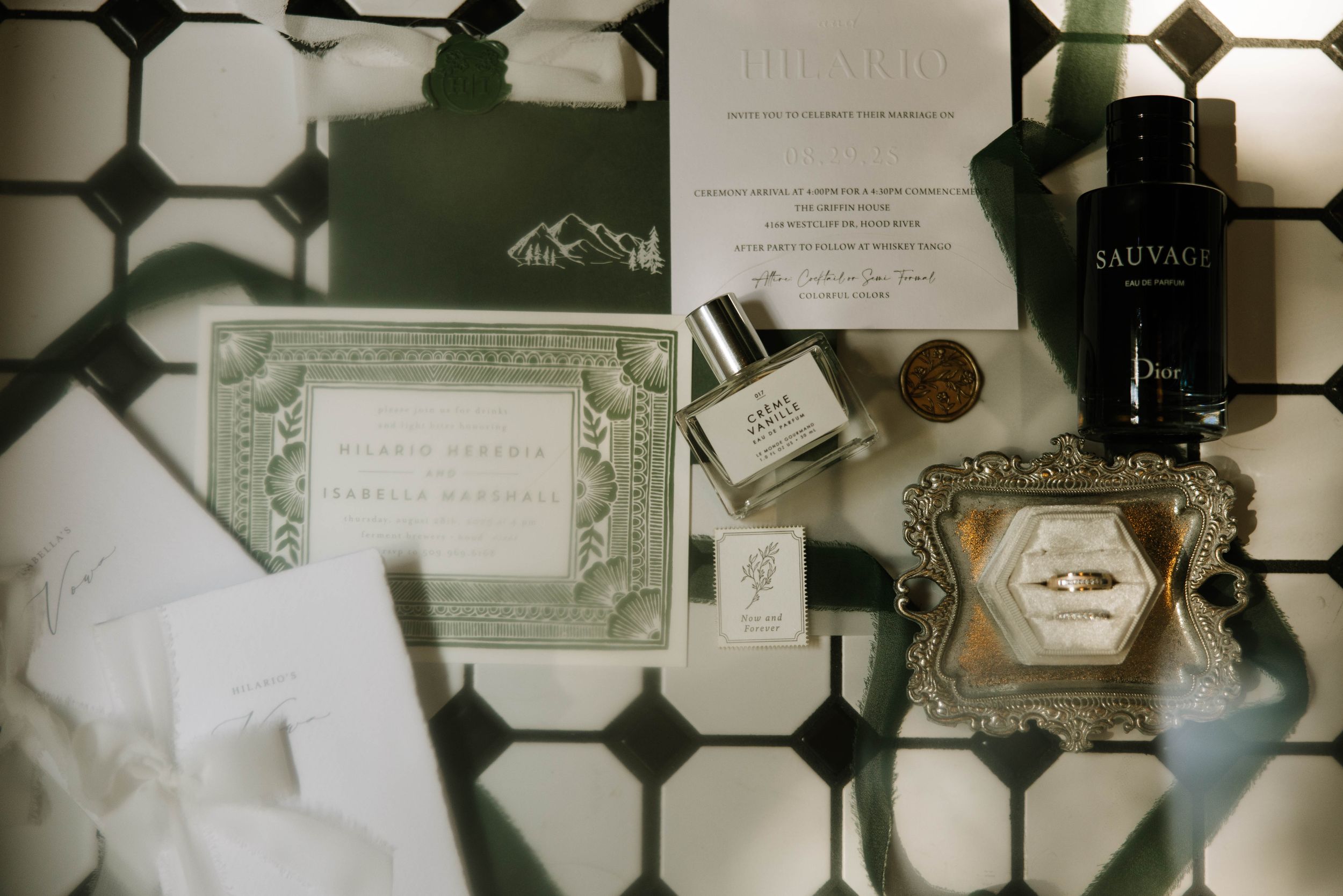 Wedding invitation and detail cards arranged on a geometric patterned surface.