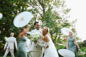 Artistic motion capture of wedding celebration with blurred movement in garden setting.